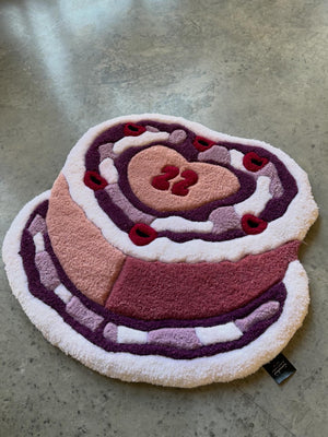 Close-up of the hand-tufted pile on the Birthday Cake rug, with red cherries and plum icing thumbnail 2